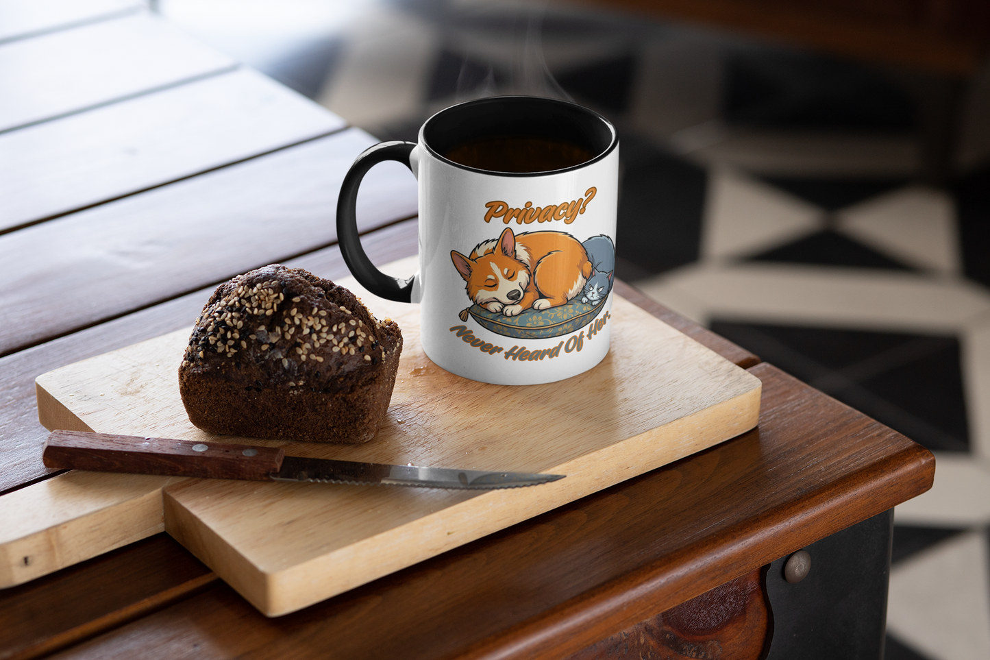 Mug with a dog design on a wooden table with a muffin and knife.