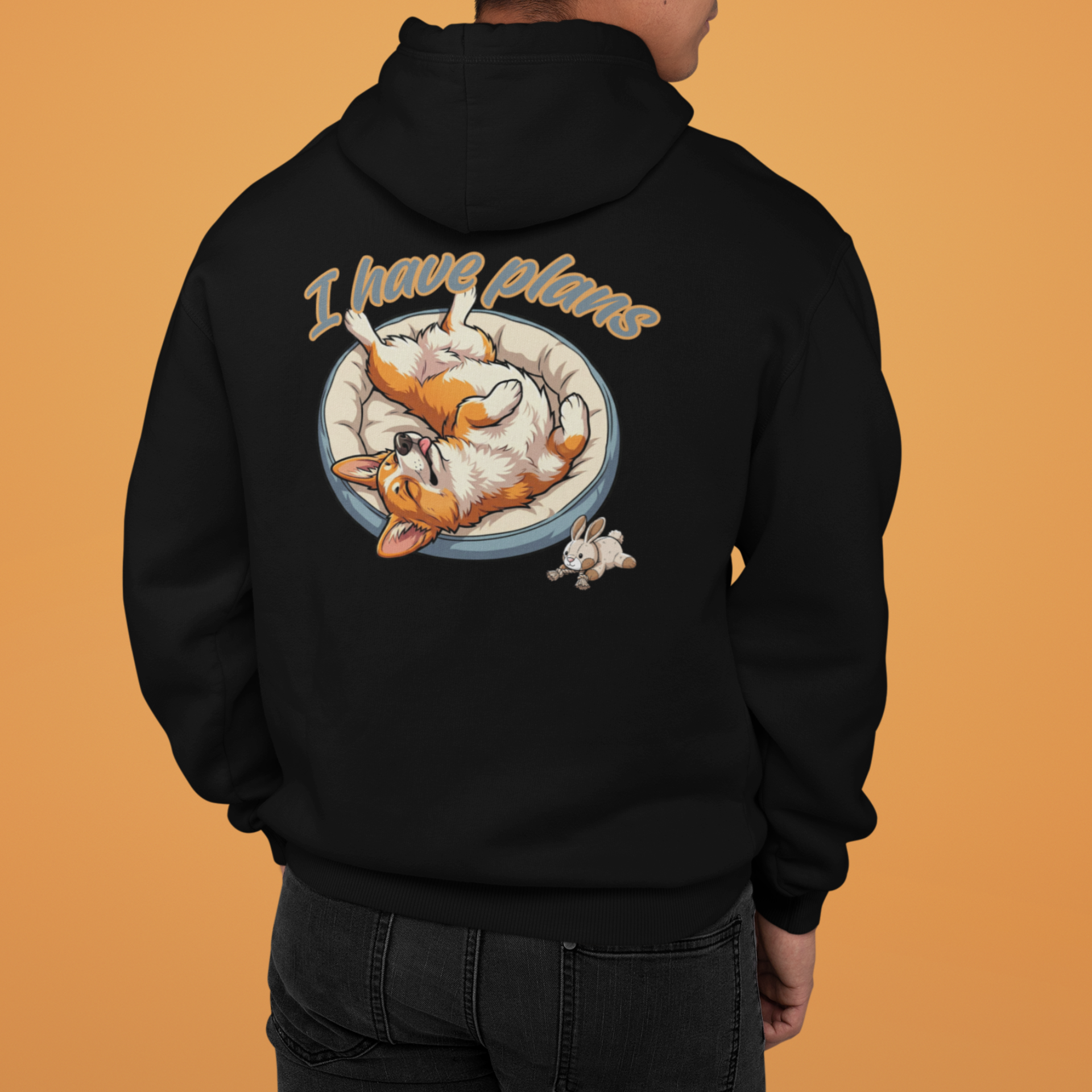 Person wearing a black hoodie with a graphic design on the back against an orange background