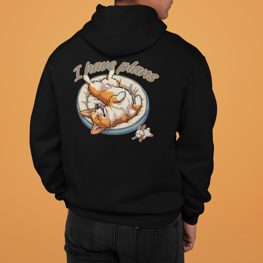 Person wearing a black hoodie with a graphic design on the back against an orange background