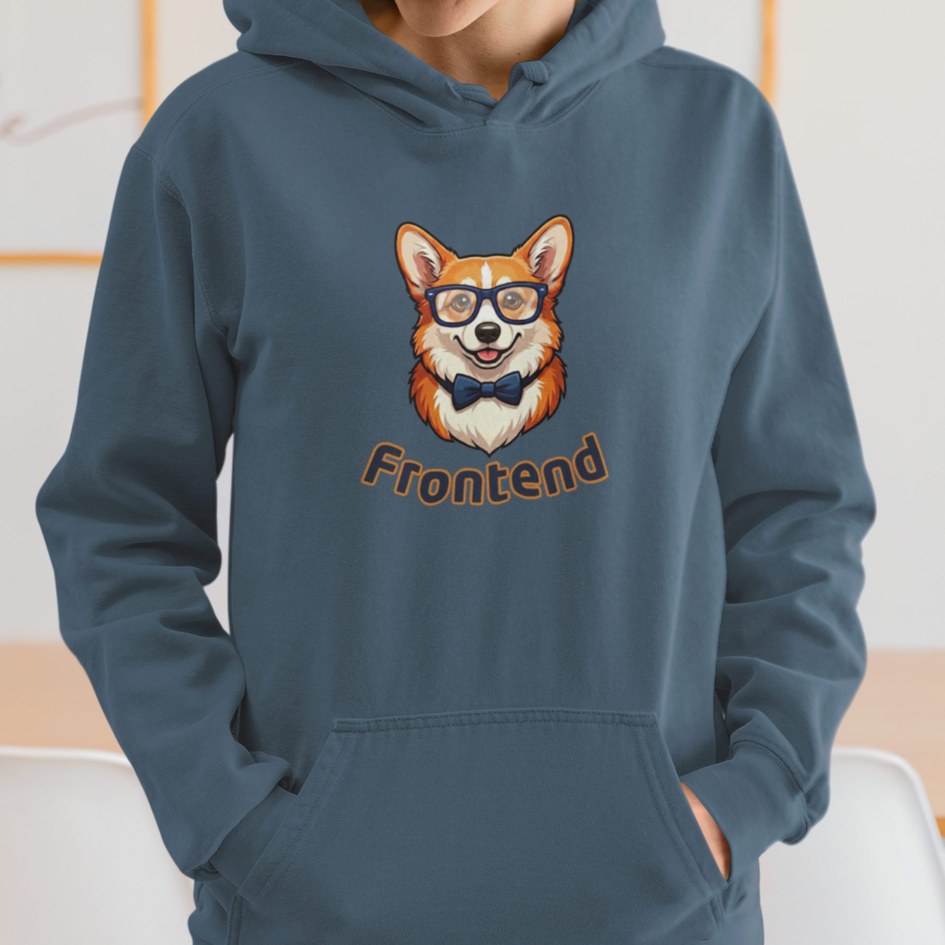 Person wearing a blue hoodie with a dog graphic and 'Frontend' text, standing indoors.