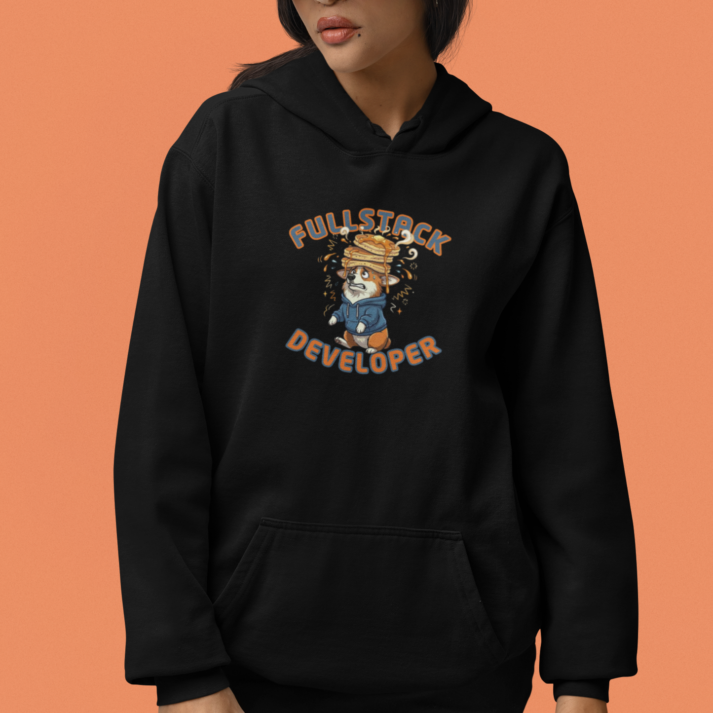 Person wearing a black hoodie with a graphic design on an orange background