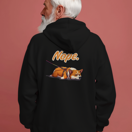 Person wearing a black hoodie with a dog graphic and 'Nope' text on the back against a pink background